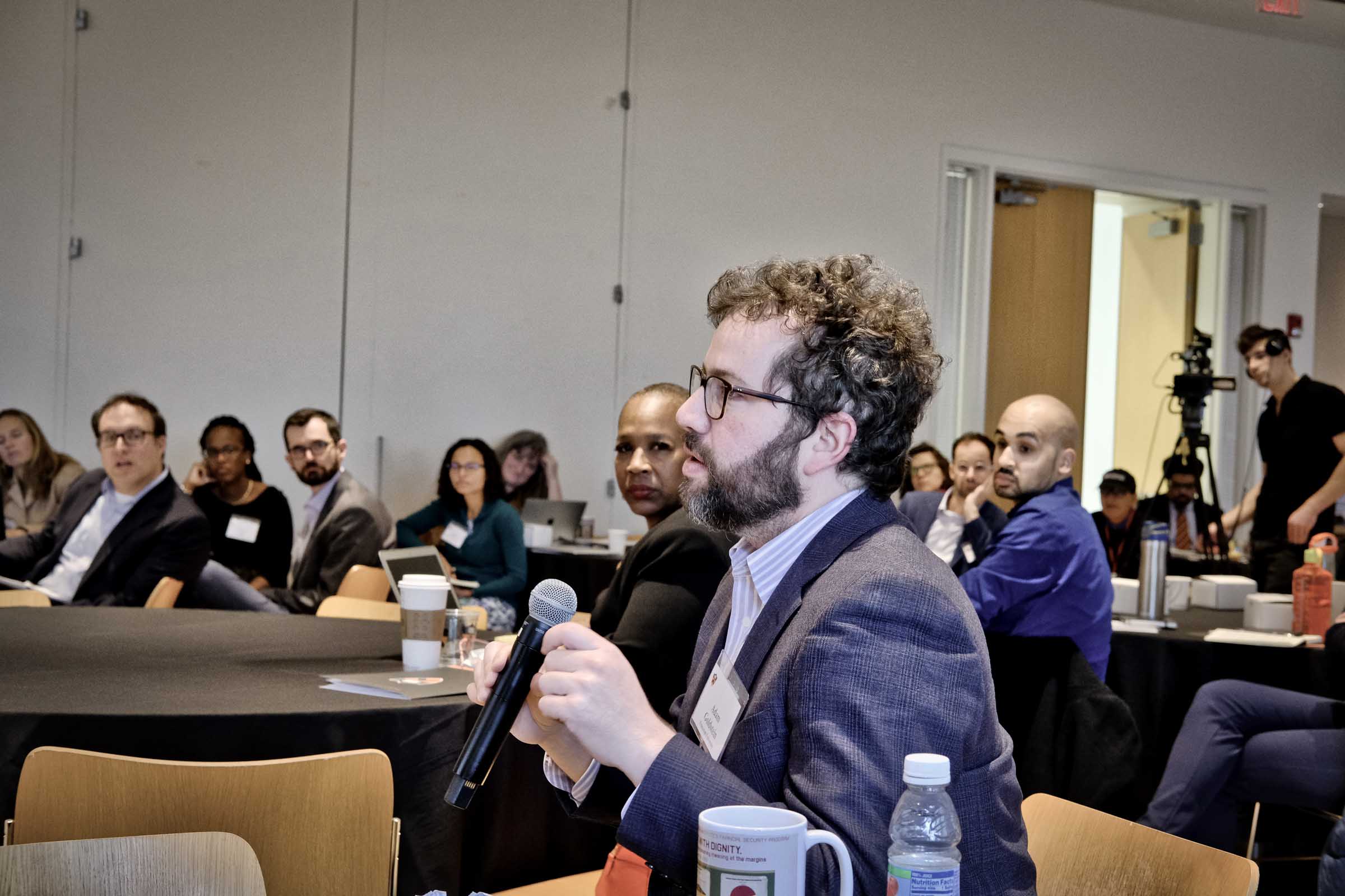 Conference participants ask questions of the panelists